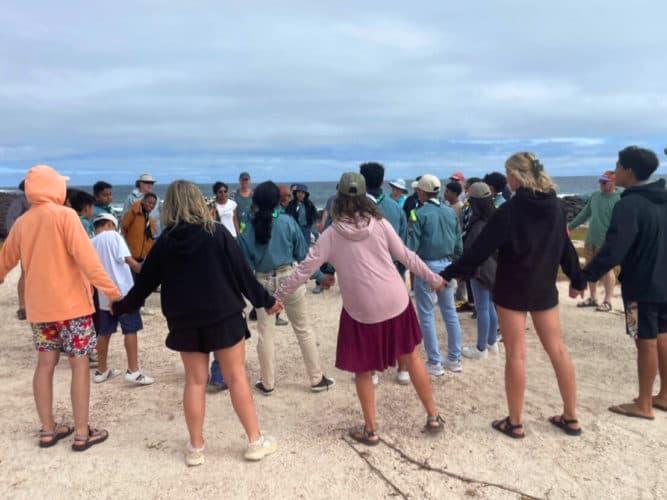 Students and local scouts collecting mesoplastics from the beach.